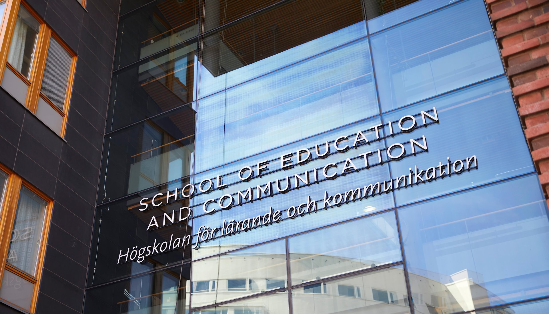The sign over the entrance to the School of Education and Communication 