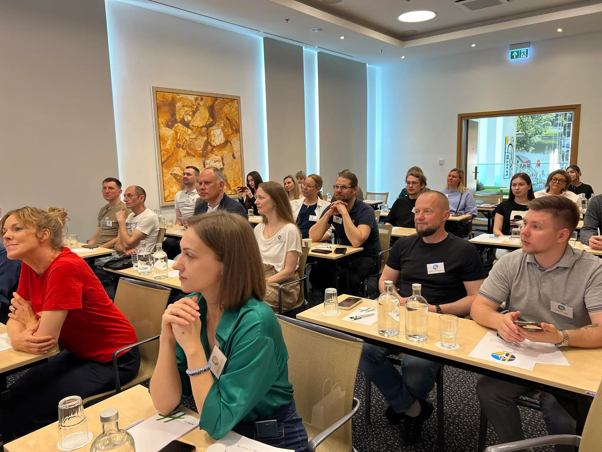 A group of people listen to a presentation.