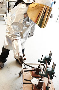 Person in lab coat melting aluminium 