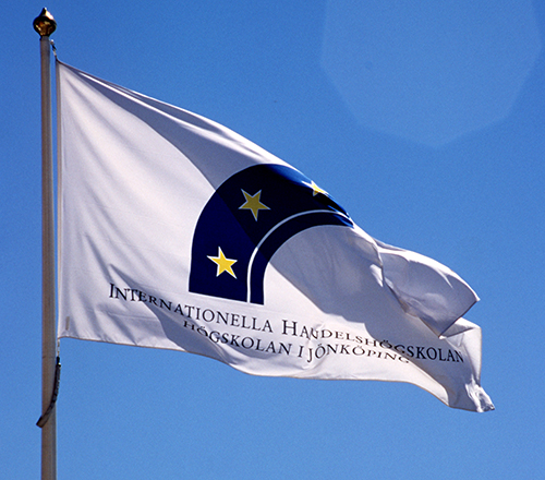 A flag with the JIBS logotype used from 1994 to 2015