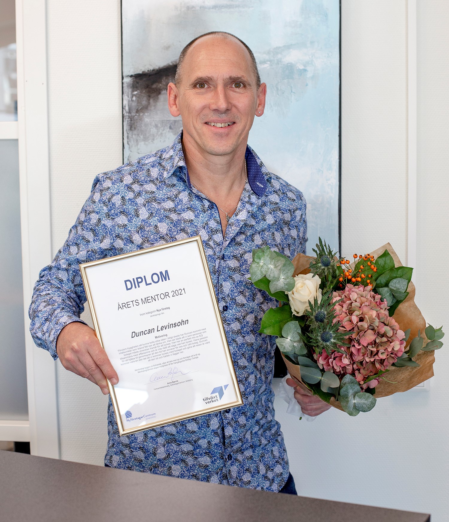 Man holding certificate award