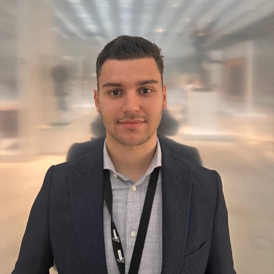 JU student looking into the camera at a conference