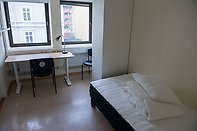 Student dorm room with bed and desk